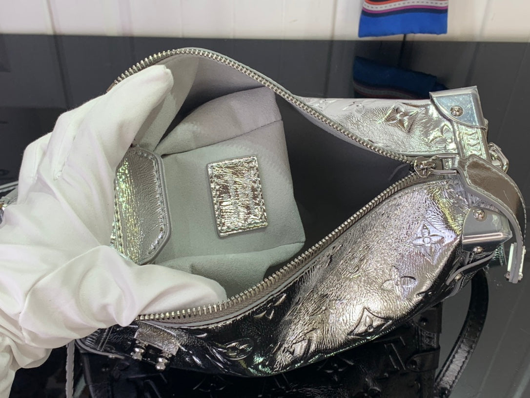 Louis Vuitton silver monogram shoulder bag with open top, lining, and zipper hardware