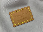 Tan leather logo patch reading Louis Vuitton Paris with yellow border stitching