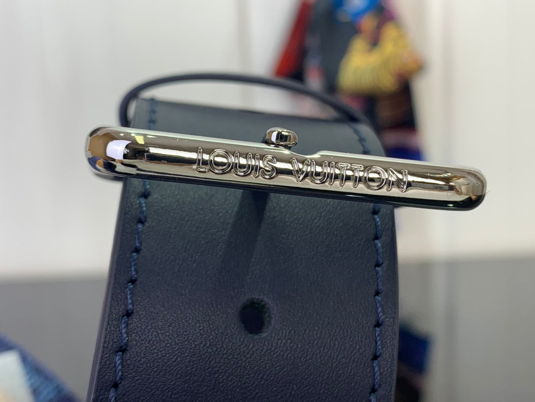 Blue belt bag with silver-tone logo bar hardware on front pocket