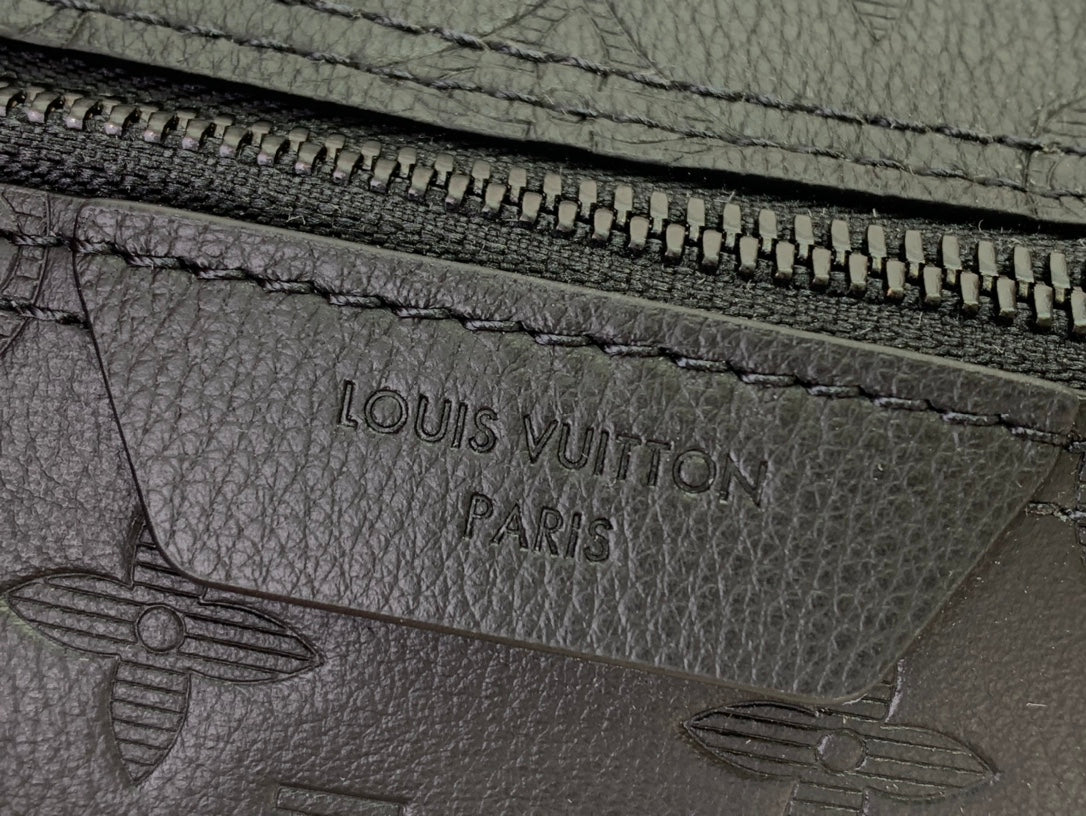 Louis Vuitton monogram zip pull area with engraved 'Louis Vuitton Paris' text