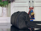Dark monogram cylindrical duffel bag with zip closure and shoulder strap