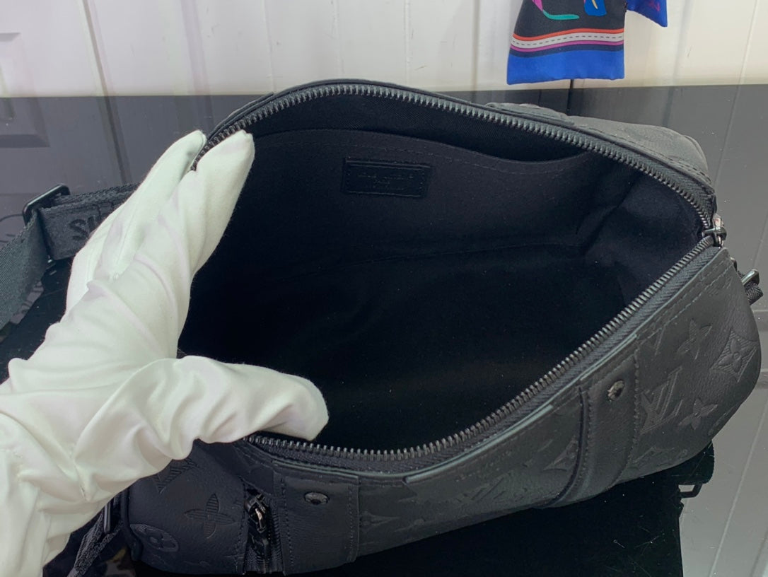 Dark duffel bag interior with zip opening and monogram fabric lining