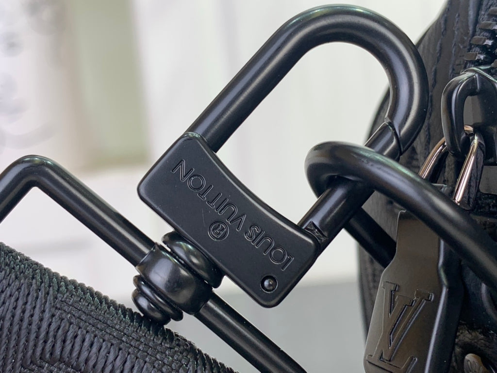 Dark bag hardware with embossed “LOUIS VUITTON” on the strap connector