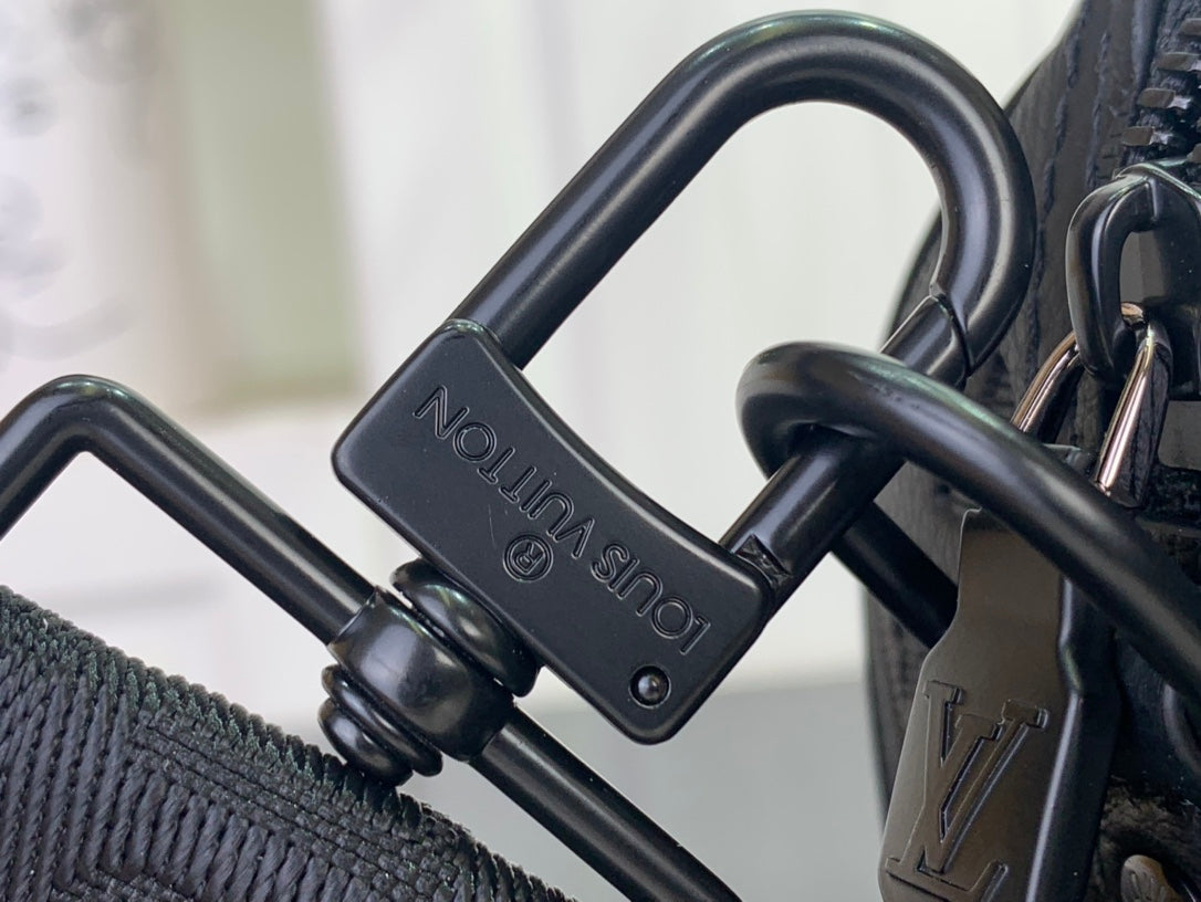 Dark bag hardware with embossed “LOUIS VUITTON” on the strap connector