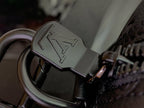 Louis Vuitton monogram metal clip on dark bag strap