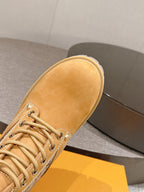 Tan suede lace-up ankle boot with rounded toe and lace-up stitching details