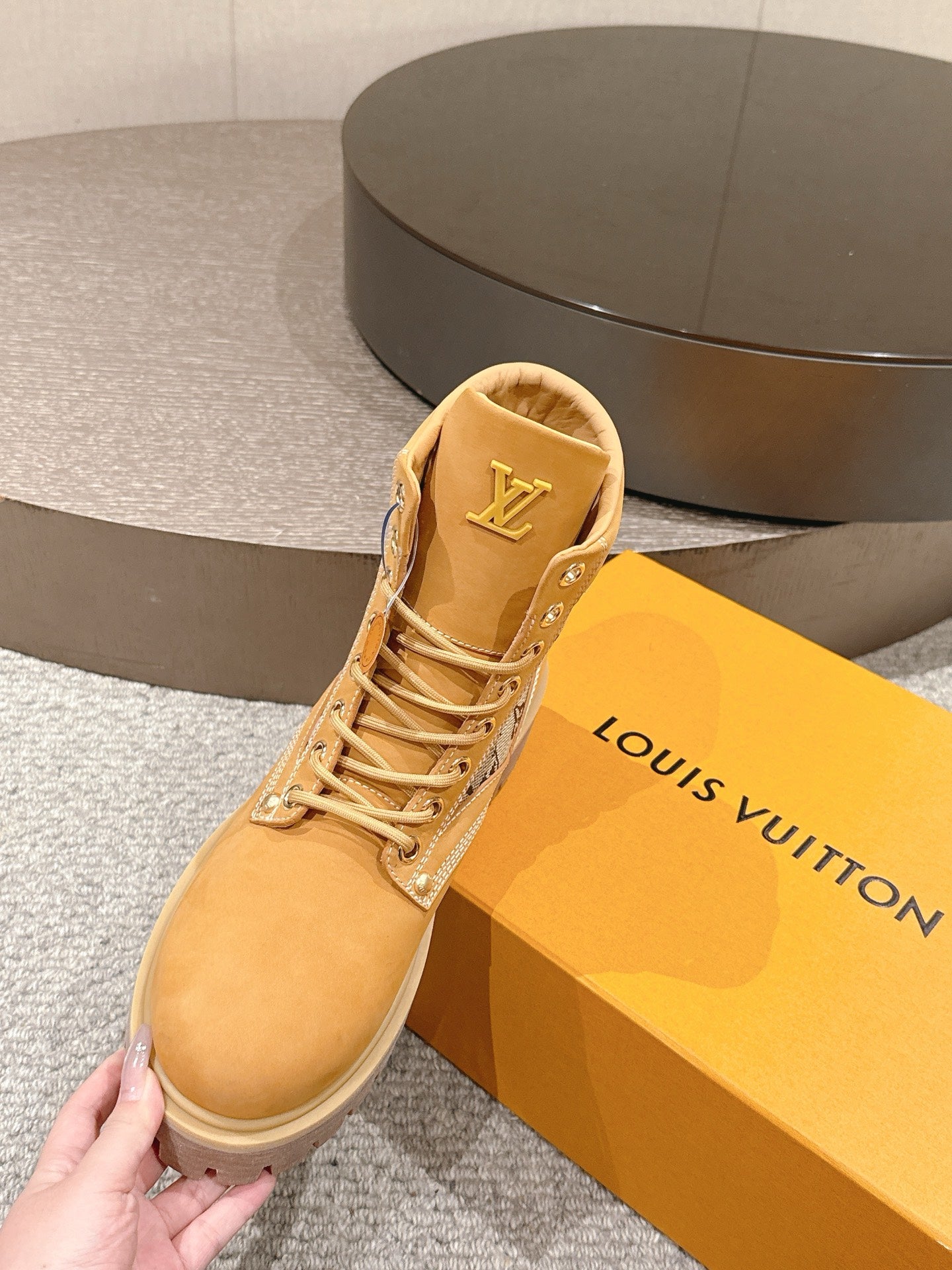 Tan suede lace-up ankle boot with LV logo on tongue and padded collar