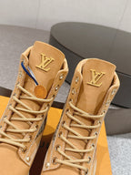 Close-up of tan lace-up ankle boots with LV logo on tongue and monogram side trim