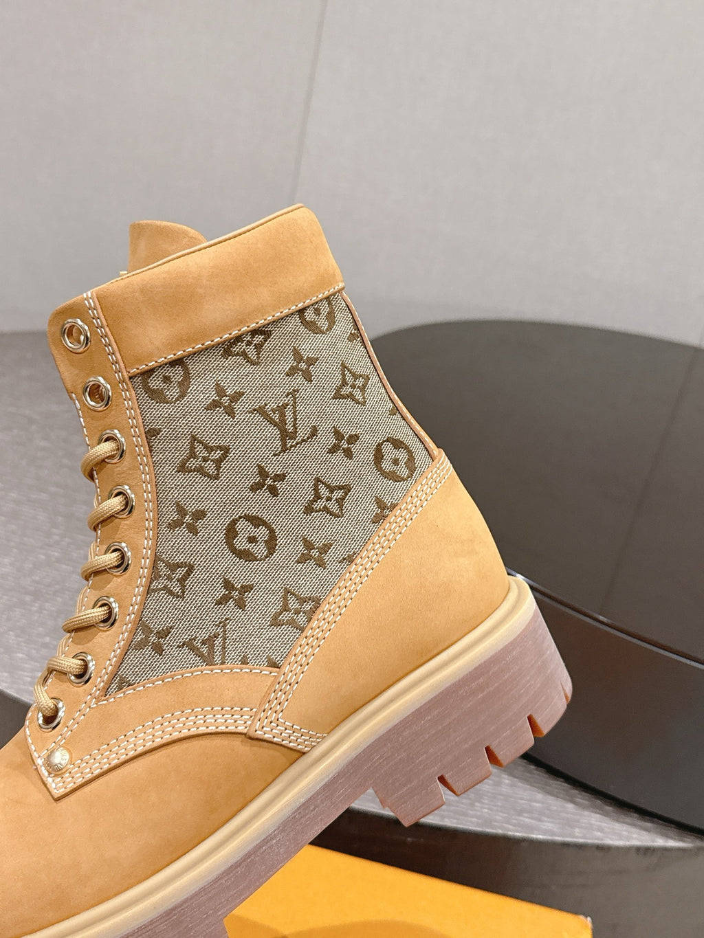 Tan lace-up ankle boots with monogram canvas side panel and padded ankle collar