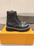 Black lace-up leather boots with embossed monogram pattern and thick rubber sole