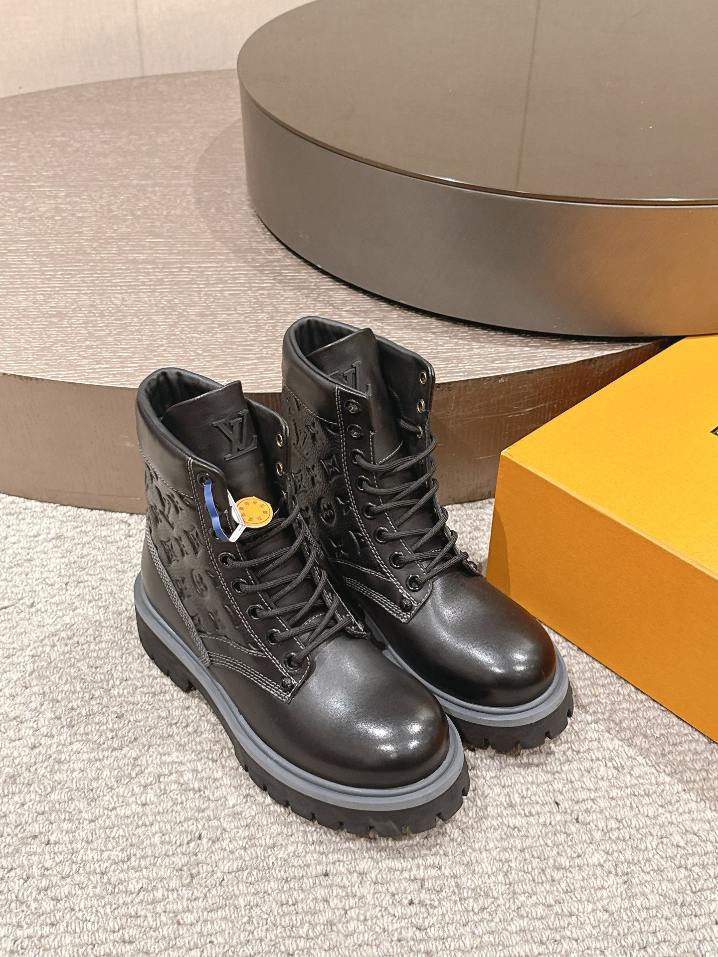 Black lace-up leather boots, side view, chunky tread sole