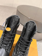 Black high-top lace-up boots with LV logo on tongue, grippy rubber sole