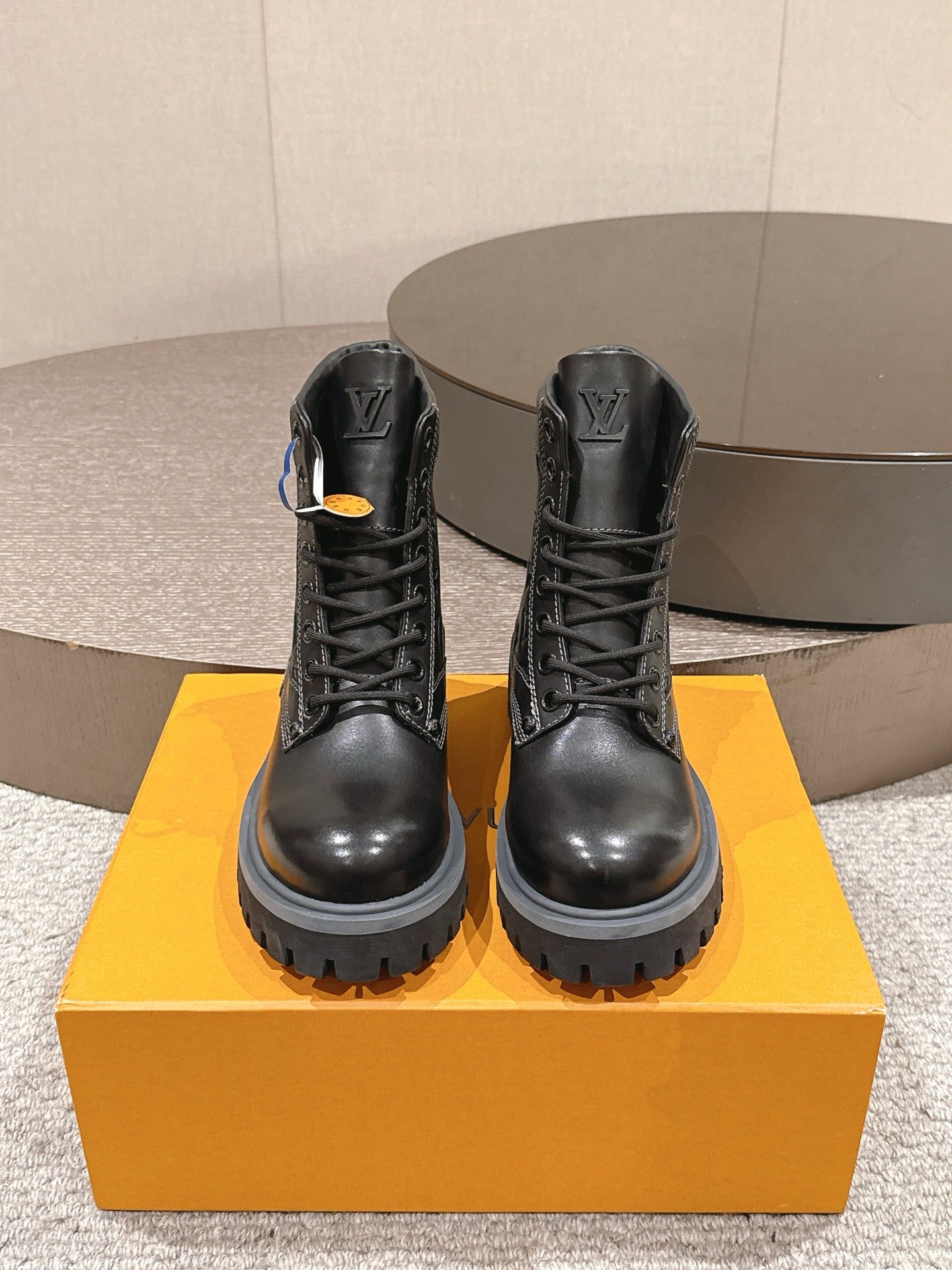 Black lace-up leather boots pair, front view, stacked lug sole