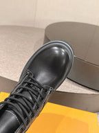 Black leather boot toe and laces, smooth finish, thick rubber sole