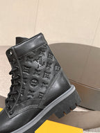 Black high-top lace-up boots with embossed monogram panel and lug sole