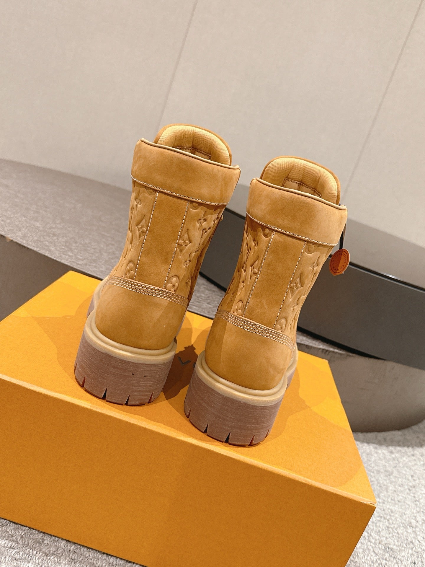 Tan suede lace-up ankle boots with high padded collar and stacked rubber sole