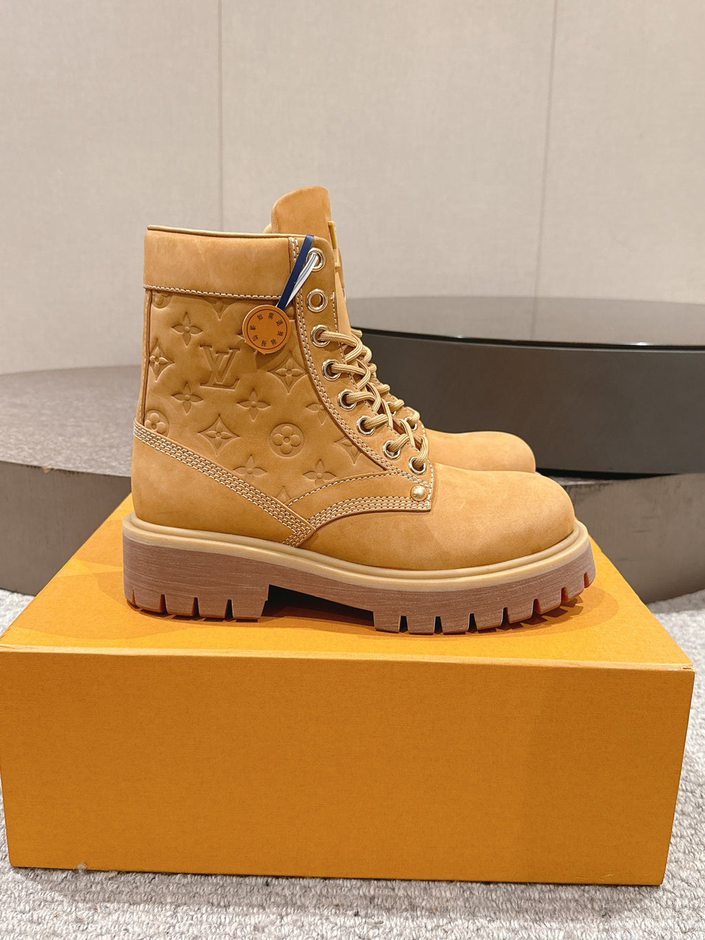 Tan suede ankle boot with lace-up front and LV monogram on side
