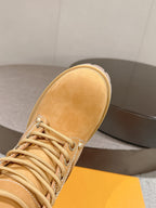 Tan suede lace-up ankle boot close-up, showing textured upper and stitching detail