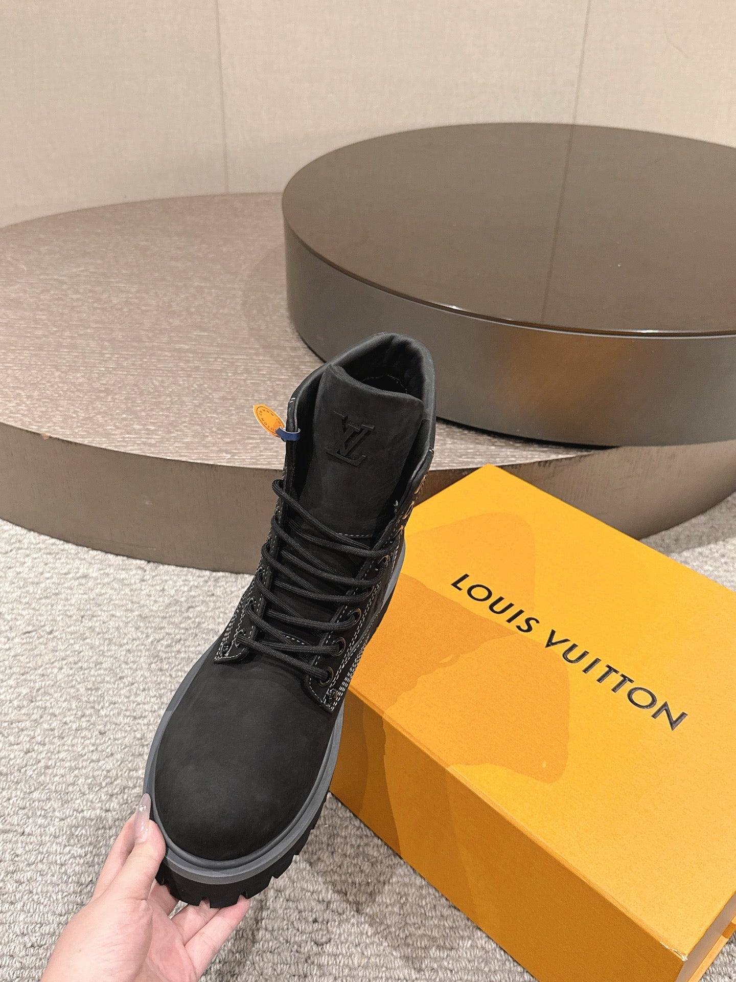 Louis Vuitton unisex black lace-up high-top boot, hand holding, cushioned collar