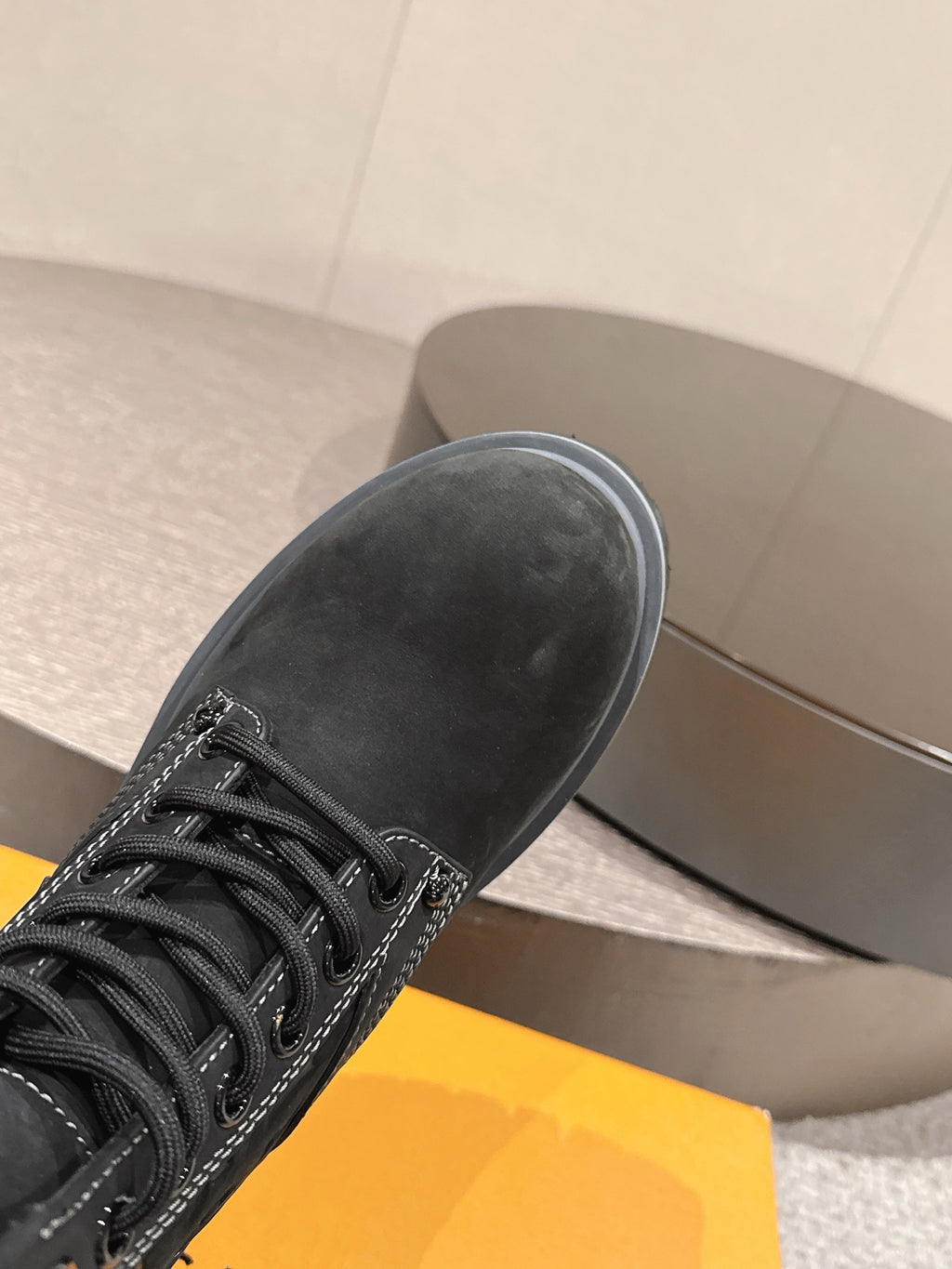 Louis Vuitton unisex black lace-up boot, close-up toe and laces, rubber sole