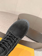 Louis Vuitton unisex black lace-up boot, close-up toe and laces, rubber sole