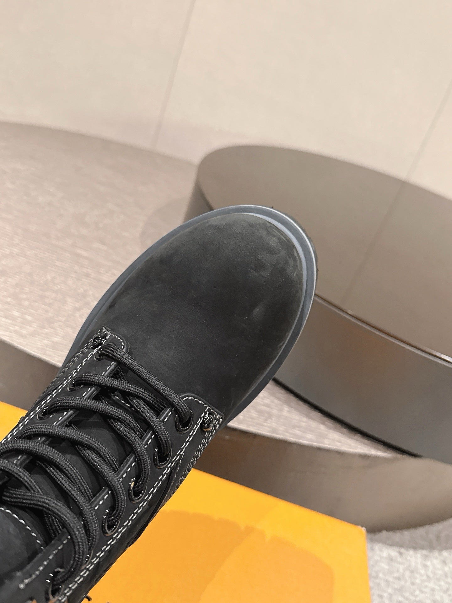 Louis Vuitton unisex black lace-up boot, close-up toe and laces, rubber sole