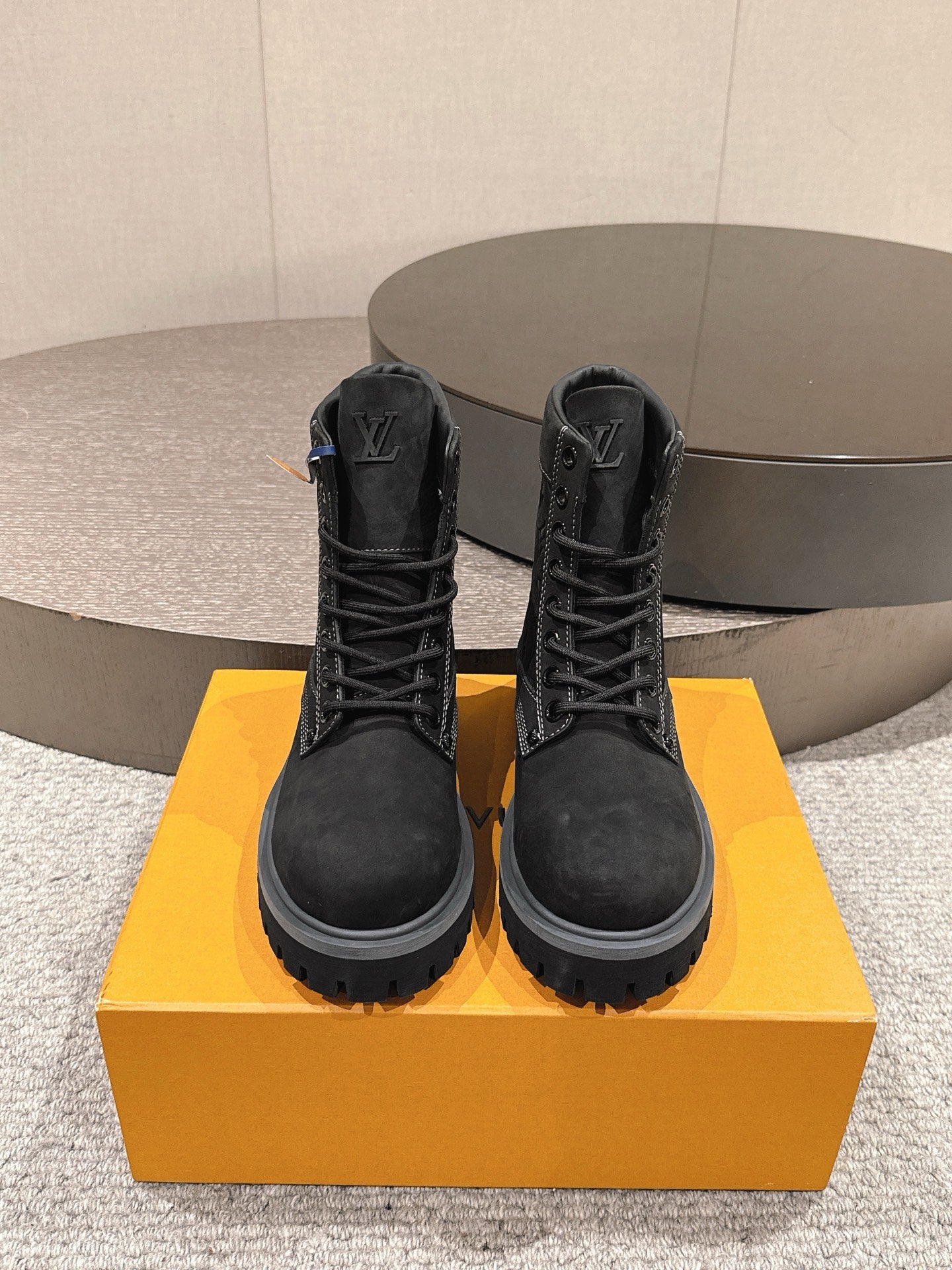 Louis Vuitton unisex black lace-up high-top boots, front view pair, chunky tread sole