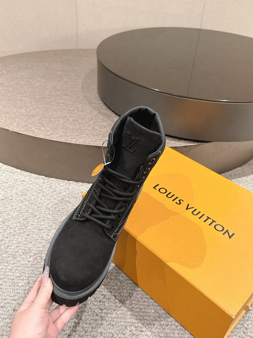 Black lace-up ankle boots with pull tab and Louis Vuitton logo on tongue