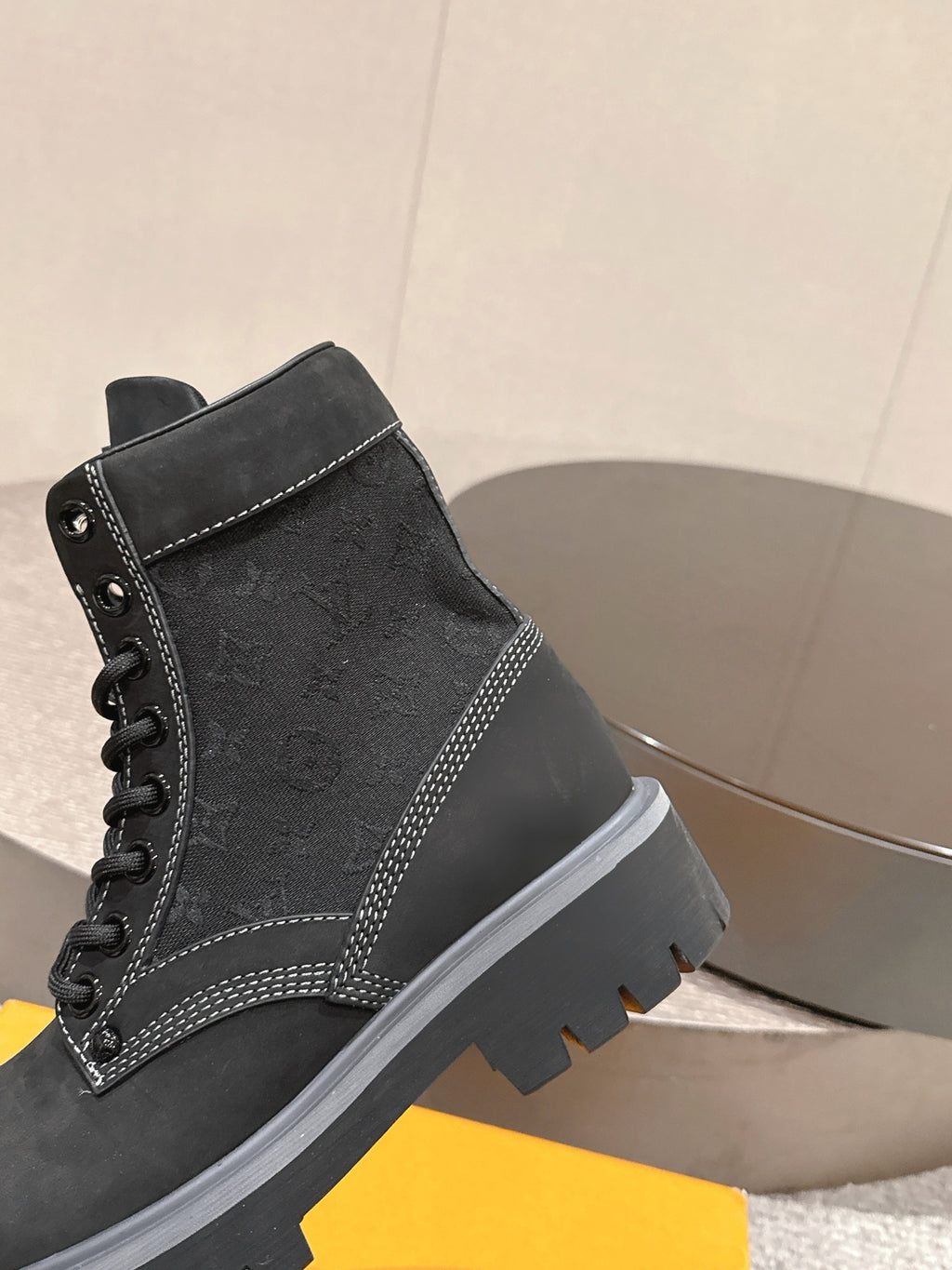 Black lace-up ankle boot with contrast stitching and padded collar