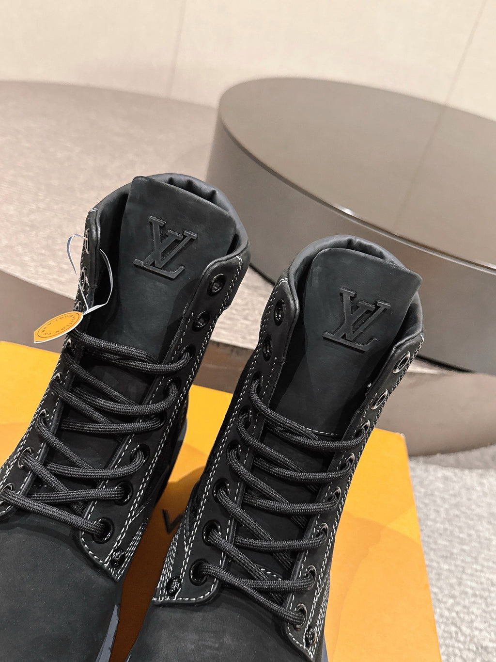 Black suede lace-up boots with embossed Louis Vuitton logos on side panels
