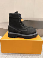 Black suede ankle boots with lace-up front, Louis Vuitton logo on side and tag