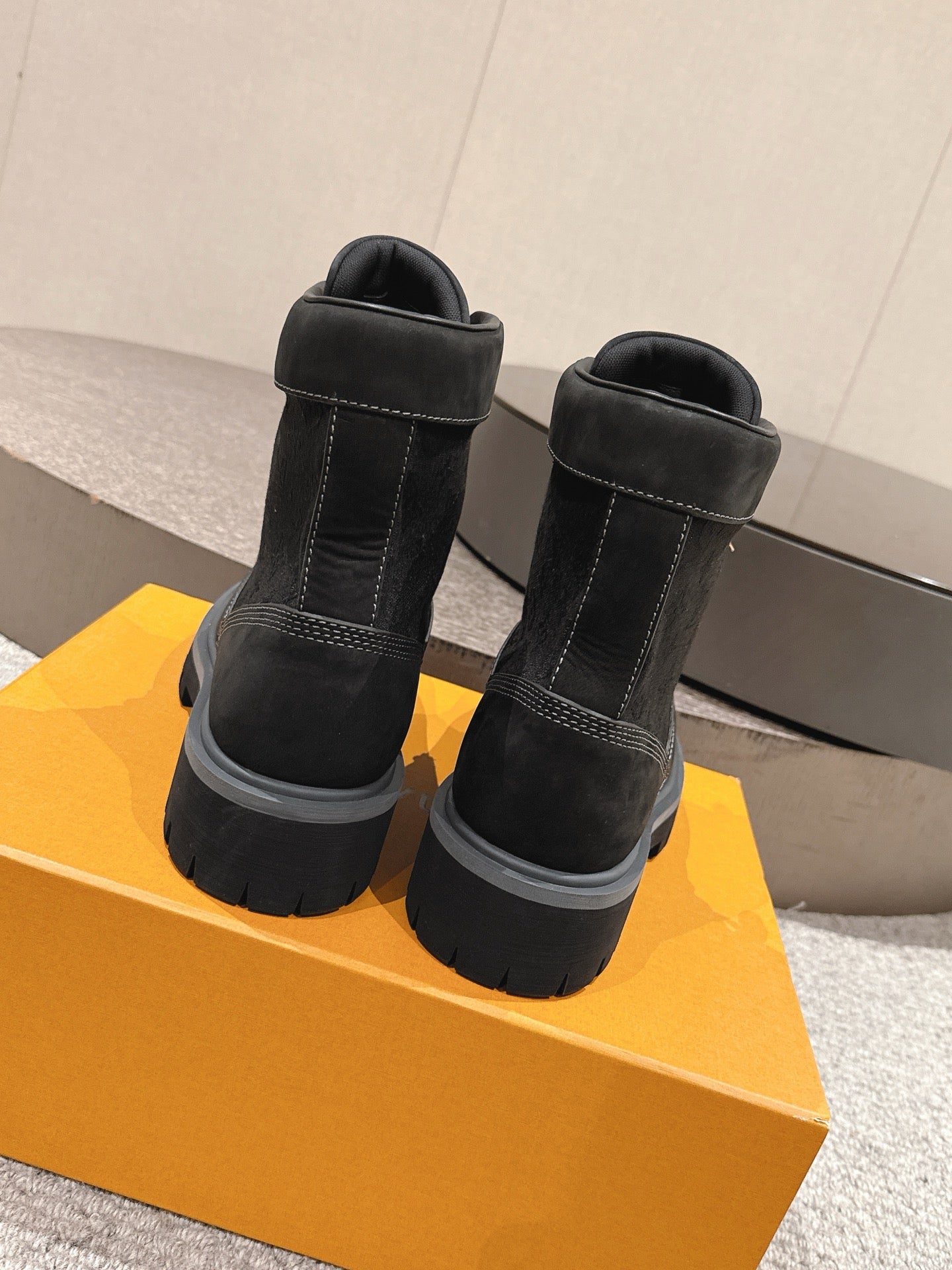 Black high-top ankle boots with padded collar and lace-up front