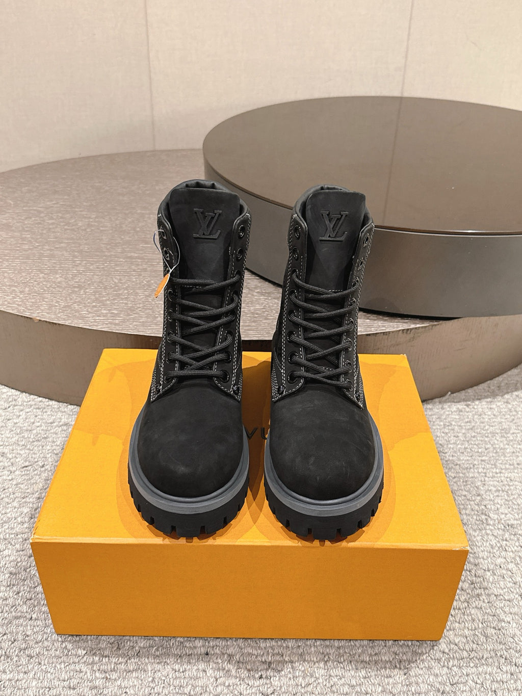 Black lace-up ankle boots, pair view, embossed Louis Vuitton logo on tongue