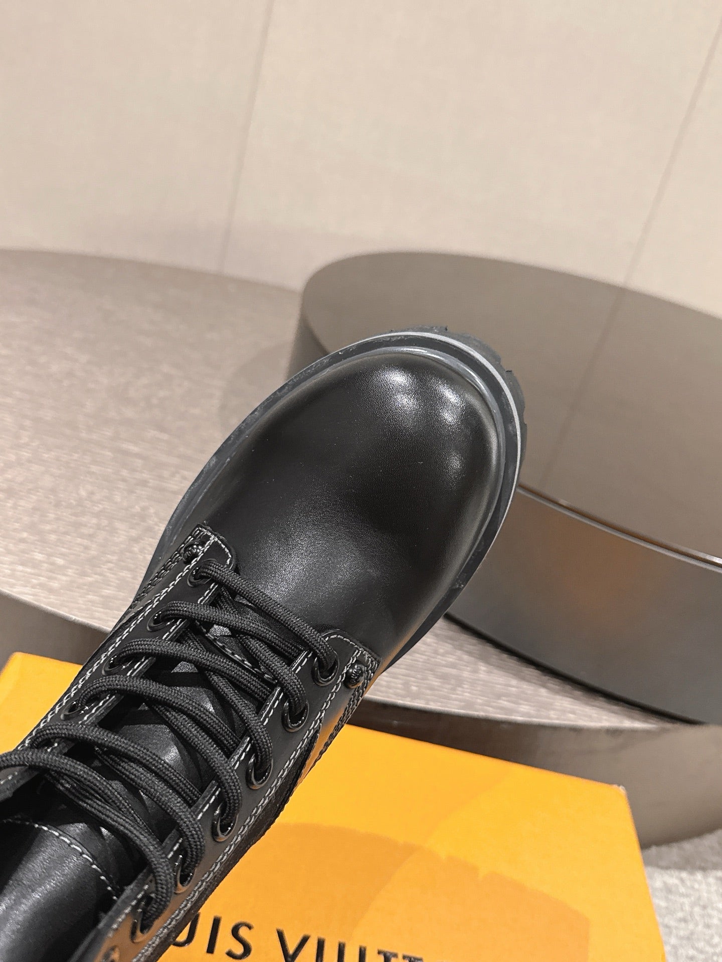 Louis Vuitton unisex black leather lace-up boot, close-up toe and laces on platform sole