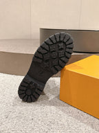 Louis Vuitton unisex lace-up ankle boots, outsole view with tread pattern and logo details