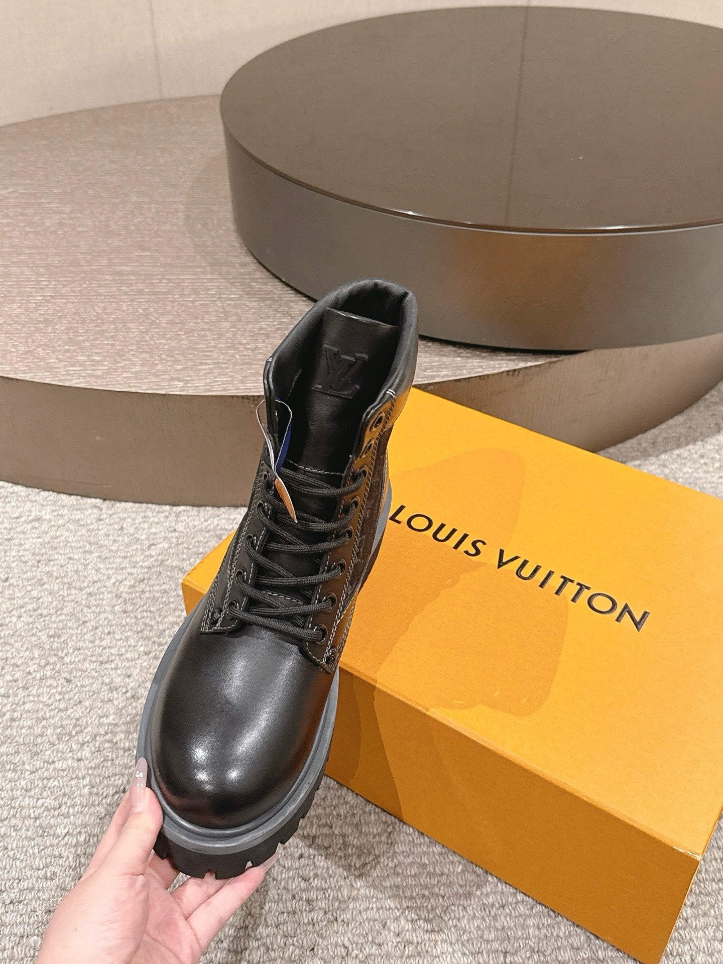 Louis Vuitton unisex black leather lace-up ankle boots, side view with thick tread sole