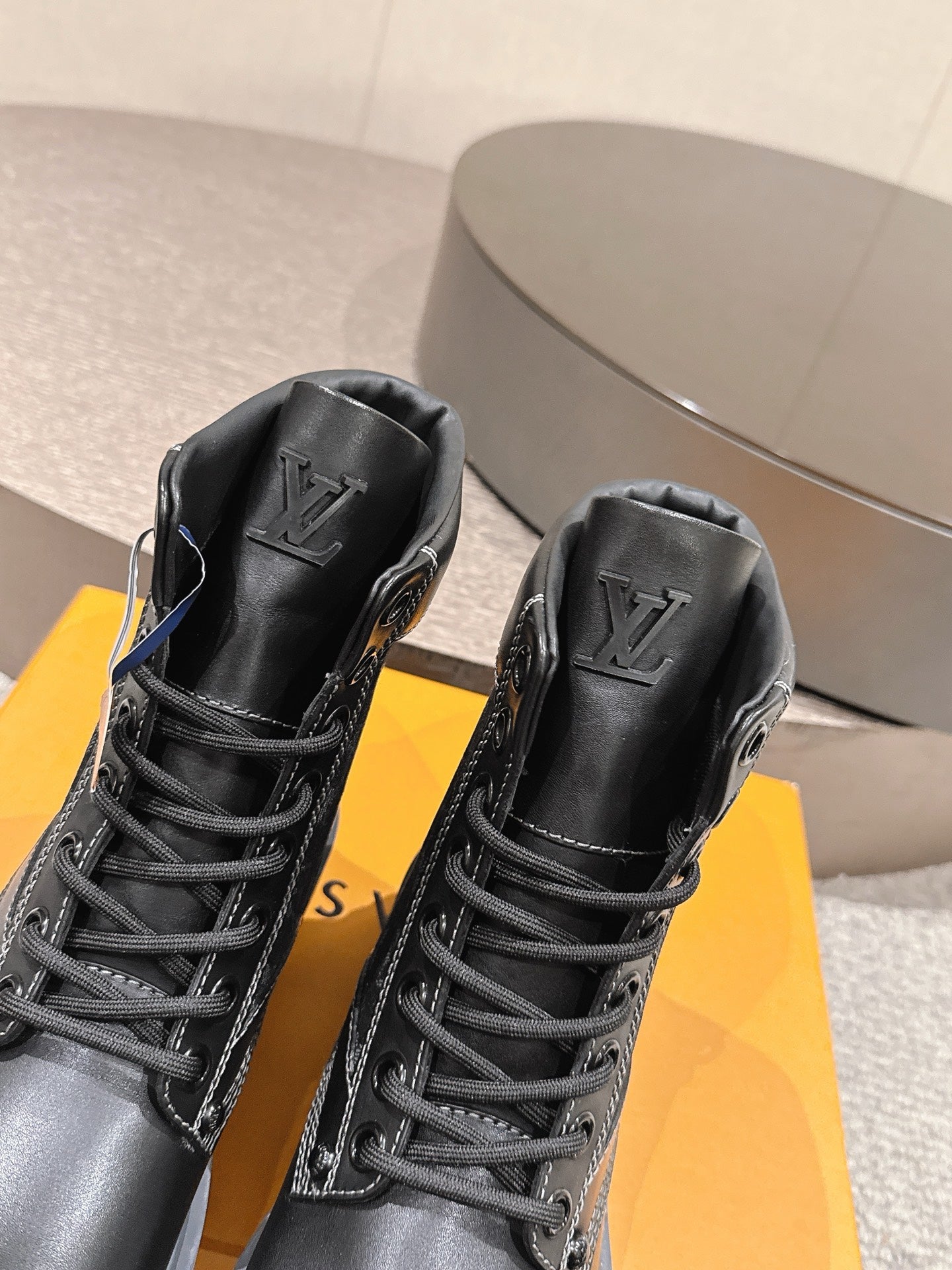 Louis Vuitton unisex black lace-up ankle boots, close-up front with logo embossed collars