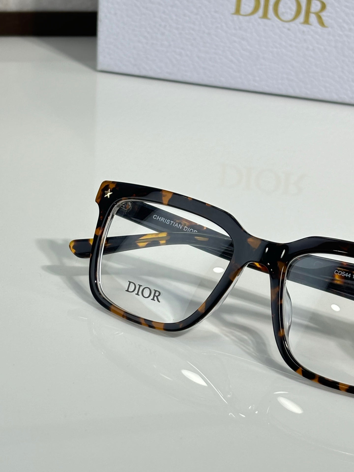 Dior eyeglasses with tortoise-pattern frame and clear lenses, angled view