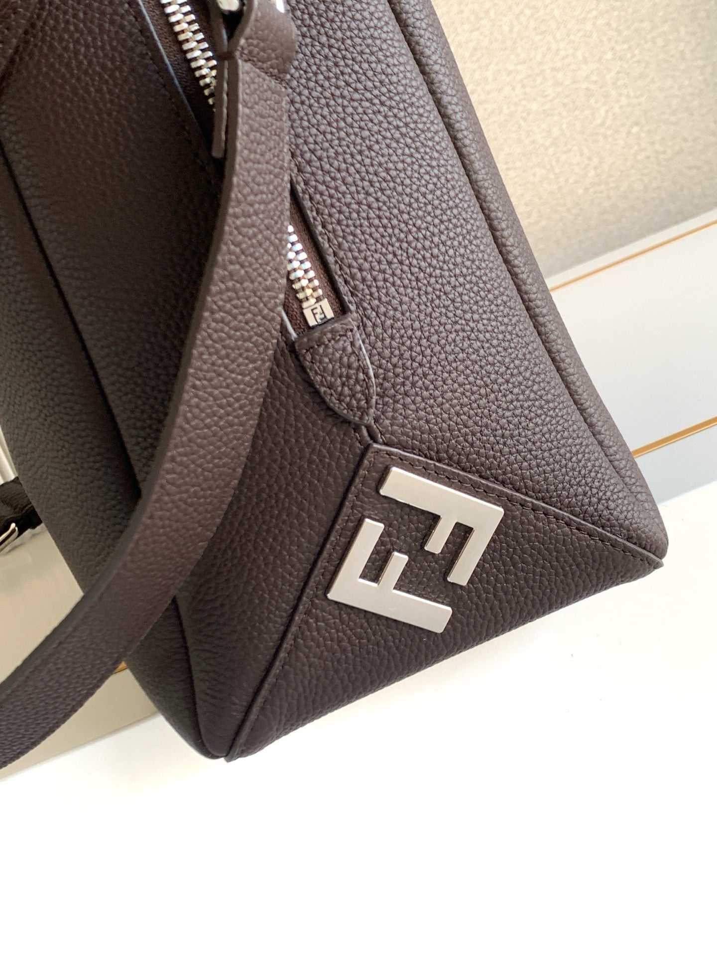 Fendi mini bag front panel with FF logo, dark brown pebbled leather