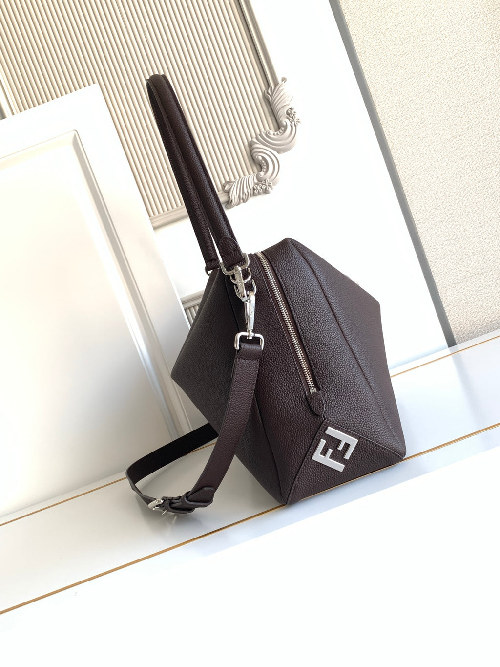 Fendi mini bag in dark brown pebbled leather, side strap and FF logo patch