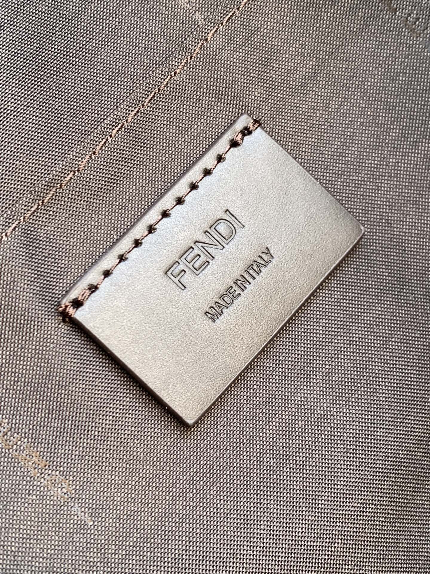Fendi Made in Italy tag on dark brown pebbled leather bag