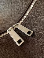 Fendi zipper detail on dark brown pebbled leather bag, metal pulls