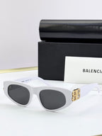 White cat-eye sunglasses with dark lenses and gold B logo on temples