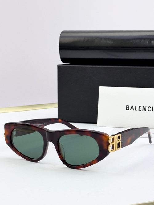 Tortoiseshell cat-eye sunglasses with green-tinted lenses and gold B logo