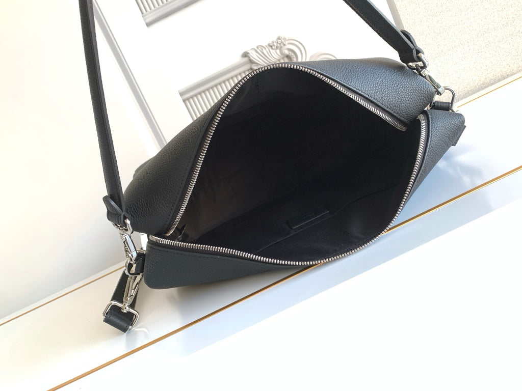 Black leather crossbody bag with zip-top closure and open interior view