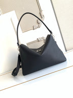 Dark leather shoulder bag with curved top and adjustable crossbody strap