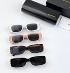 Balenciaga sunglasses assortment in white, pink, tortoiseshell, and black with gold B hardware