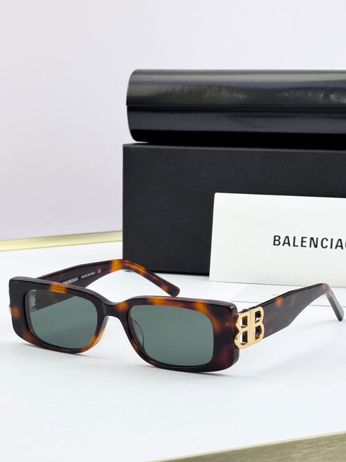 Balenciaga sunglasses with tortoiseshell frames, gold B logo temples, dark lenses