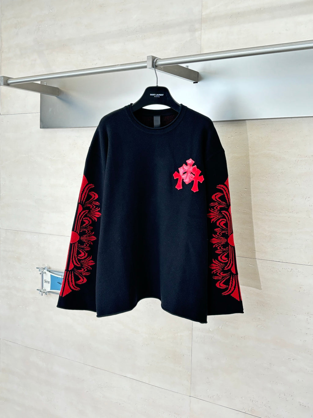 Black long-sleeve top with red and black embroidered-style front graphic