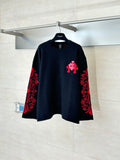 Black long-sleeve top with red and black embroidered-style front graphic